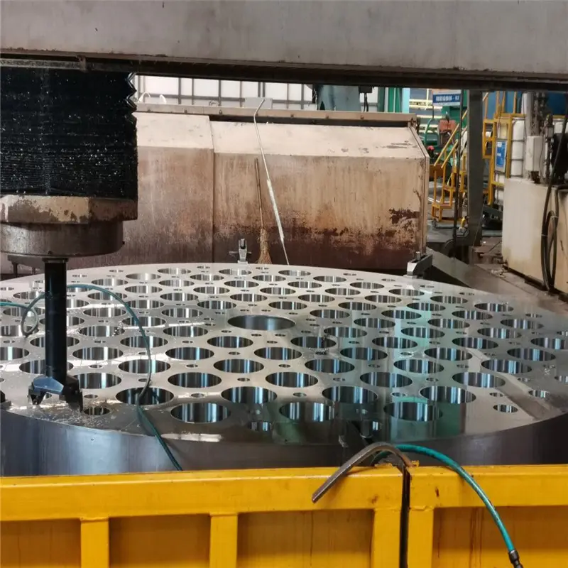 Precision machined stainless steel tube sheet by multi-hole drilling