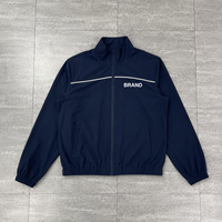 Fabricants de vêtements sur mesure : Survêtements oversize zippés, ensembles de survêtements en nylon avec impression sérigraphiée, coupe-vent à passepoil pour hommes