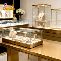 Vitrine à bijoux moderne avec éclairage LED, finition dorée, tiroirs de rangement pour les boutiques de diamants des centres commerciaux - Couleurs et dimensions personnalisables