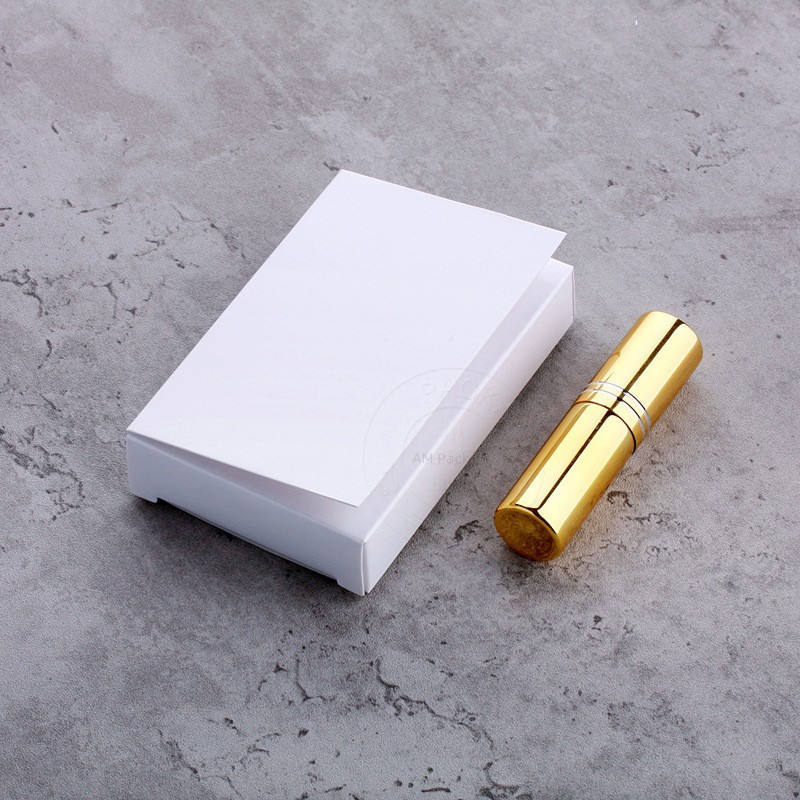 Gold perfume spray bottle with white box