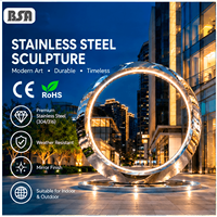 Sculpture circulaire en acier inoxydable poli miroir BSA avec éclairage LED 304/316, grande statue métallique pour l'aménagement paysager extérieur des places publiques