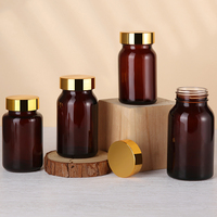 Bouteille en verre de qualité alimentaire de couleur ambrée brillante personnalisée pour produit de soin masculin avec bouchon déshydratant en or brillant