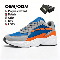 Chaussure décontractée d'hiver bleu roi de luxe discret, en cuir premium et daim gris avec accents orange, modèle Wave Trainer confortable à lacets