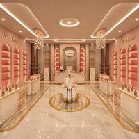 Conception d'intérieur de boutique de cosmétiques et de parfums de luxe, comptoir de réception en marbre sur mesure, présentoir cylindrique, solution d'aménagement complète de la boutique