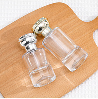 Flacon de parfum cylindrique de luxe en verre 55ML, fond en forme de montagne avec couvercle rond en forme de fleur or et argent
