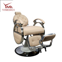 Fauteuil de barbier inclinable robuste de style rétro, en cuir capitonné beige, avec structure en métal poli, rotation à 360°
