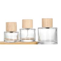 Bouteilles de parfum rondes en verre écologiques en gros 30/50/100ml avec pompe pulvérisatrice, diffuseur à bâtonnets et surface décalquée pour parfum et crème visage