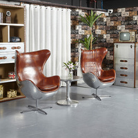 Fauteuil lounge pivotant en cuir Spitfire, design italien classique, avec dossier en aluminium, pour salon.