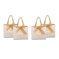 Petits sacs-cadeaux portables de luxe or et blanc avec ruban pour bijoux montres cosmétiques vêtements pour mariages merci impressions