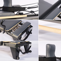 Reformer Pilates à cadre noir avec barre de pieds en bois, longue boîte et poulie réglable pour l'entraînement à domicile et en studio