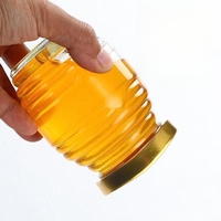 Pots en verre de forme claire vide de nid d'abeilles de catégorie comestible pour le miel avec des couvercles en métal