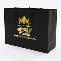 Sac en papier de luxe personnalisé avec logo, noir mat, en carton, avec poignées en corde de coton enduite d'or, vente en gros