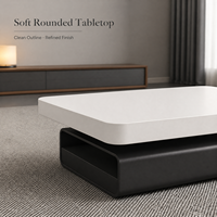 Table basse contemporaine avec surface blanche arrondie et base noire pour salon 110 x 60 x 42 cm