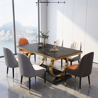 Table à manger extensible moderne de luxe avec plateau en pierre frittée marbre noir Marquina et base en acier inoxydable plaqué or pour villa