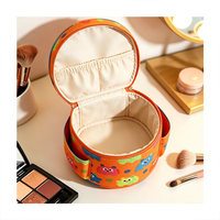 Sac cosmétique rond à poignée supérieure, imprimé monstre coloré, poches latérales, organiseur de maquillage pour les voyages et l'usage quotidien