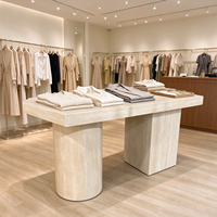 Table d'exposition îlot pour vêtements à texture pierre, comptoir pliant de présentation de vêtements au sol pour boutique féminine, présentoir îlot de luxe pour vêtements