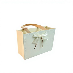 Custom Creative Ivory Board Paper Women Gift Bag <b>With</b> Flat Handles Embossed Design Ribbon <b>Bow</b> Rectangle Gift Bag For Clothes - Product Image 1