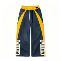 Pantalon de survêtement streetwear vintage délavé, bleu marine et jaune, avec imprimé lettres color block, coupe large, taille élastique avec cordon de serrage