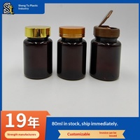 Botella de plástico PET de 80 ml color ámbar para suplementos de salud, con tapa dorada y diseño abatible con serigrafía.