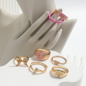 ZL-173 Kit de Joyería para Mujer, Anillos de Aleación Dorada con Cristales, Diamantes de Imitación y Esmalte en Forma de Ojo de Mariposa y Corazón, 7 Piezas - Product Image 2