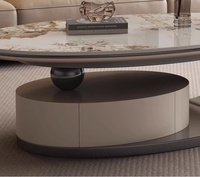 Table basse ovale moderne avec dessus en pierre frittée, pieds en métal beige, imbriqués et extensibles, pour salons confortables