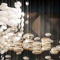 Ornement aérien personnalisé hôtel hall villa plafond décoration lustre en verre créatif doré dinosaure en forme d'oeuf suspension