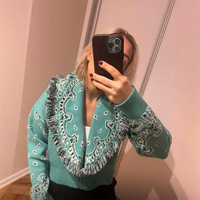 Cardigan ample en tricot jacquard motif cachemire vintage, col en V, revers à franges brutes, collection Printemps 2026