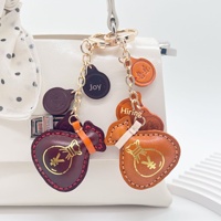 Pochette porte-bonheur best-seller en cuir véritable, pendentif fait main, porte-clés décoratif simple, accessoire de sac au design mignon, nouvelle tendance