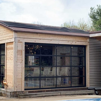 Porte de garage pliante minimaliste en verre, système de panneaux à cadre en aluminium transparent pour espace intérieur de cuisine moderne