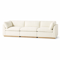 Canapé modulaire 3 places en tissu bouclé avec coussins crème et dossier bas, sectionnel avec base en bois pour salon