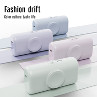Nouvelle batterie externe mini 2-en-1 de 5000 mAh avec chargeur de montre intégré, 2 ports, design capsule, charge sans fil et charge rapide