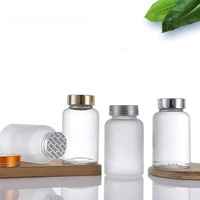 Bouteille en verre dépoli transparent en gros avec couvercle scellé pour emballage de pilules, capsules, poudres médicinales et de stockage