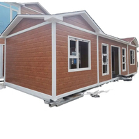 Maison modulaire préfabriquée en acier léger Zhongchen avec revêtement en bois, durable et portable, pour chantier de construction