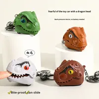 Creativo dinosaurio cabeza morder dedo tirar hacia atrás respetuoso con el medio ambiente plástico coche de juguete pequeña muñeca colgante llavero mochila para niños