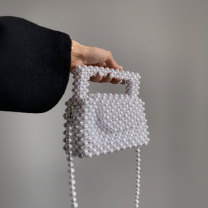 Classic <b>white</b> pearl micro mini tote bag with structured rectangular shape and a long pearl crossbody strap, at wholesale prices. - Product Image 1