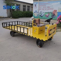 Chariot électrique à plateforme à quatre roues et direction assistée, 1 à 2 tonnes, robuste, à batterie, pour le transport de matériaux
