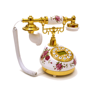 Téléphone fixe filaire vintage antique en céramique blanche avec motif de roses et cadran rotatif doré - Product Image 1