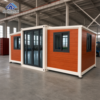 Maison modulaire extensible à double aile de 20, 30 ou 40 pieds avec porte d'entrée centrale en verre pour maison-conteneur de jardin