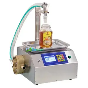 Machine de remplissage de colle d'huile comestible de remplissage de pâte de sésame au miel de type pesée machine de remplissage secondaire de sauce tomate liquide visqueux