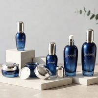 Pot cosmétique vide en verre bleu foncé OEM ODM 50g 30g avec couvercle argenté rechargeable pour crème visage et hydratant