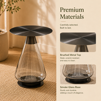 Table d'appoint ronde moderne et écologique avec plateau en acier inoxydable noir et base conique transparente fumée pour salon