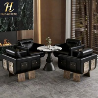 Fauteuil de salon sur mesure haut de gamme en cuir noir avec accent en métal liquide pour hôtel, villa, salon