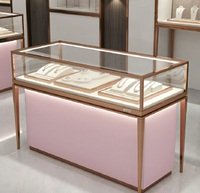 Comptoir de présentation de bijoux GZowin de luxe rose or personnalisable avec éclairage LED, vitrine de vente au détail durable et de haute qualité pour bijoux