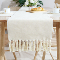 Chemin de table jacquard de couleur unie nappe en coton tissé de luxe avec pompon simple élégant à usage domestique disponible pour la vente en gros
