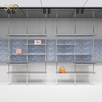 Étagère de présentation de vêtements en acier inoxydable pour boutiques et magasins de détail, design gain de place