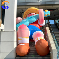 Modèle de personnage de dessin animé gonflable multicolore personnalisé, grand modèle décoratif, accessoire avec ventilateur intégré pour les escaliers des centres commerciaux, les places publiques en plein air