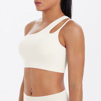 Sujetador deportivo asimétrico de un solo hombro para mujer al por mayor, con espalda recortada, transpirable, de Spandex/Nylon, soporte medio, a prueba de golpes, para correr y gimnasio.