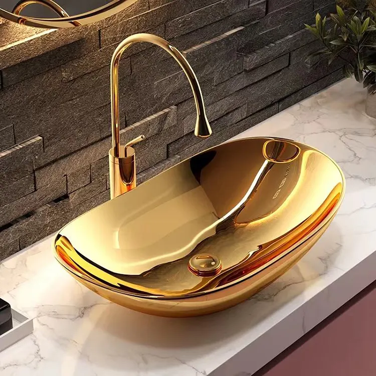 Lavabo de baño de cerámica de lujo de color dorado artístico al por mayor lavabo de baño pequeño de mostrador de oro ovalado