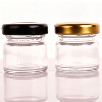 Petit pot en verre transparent de 25 ml avec couvercle en métal noir et or, vide, pour le miel de mariage, les confitures ou la conservation.