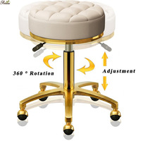 Tabouret ottoman rond de pédicure de salon de beauté en velours rose de style nordique avec base dorée